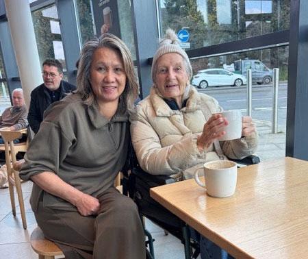 having coffee with elderly client