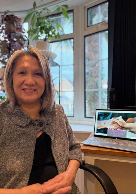 Irene sitting in chair at home